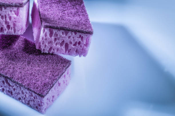 istock Violet dishwashing sponges on white surface 1077158102