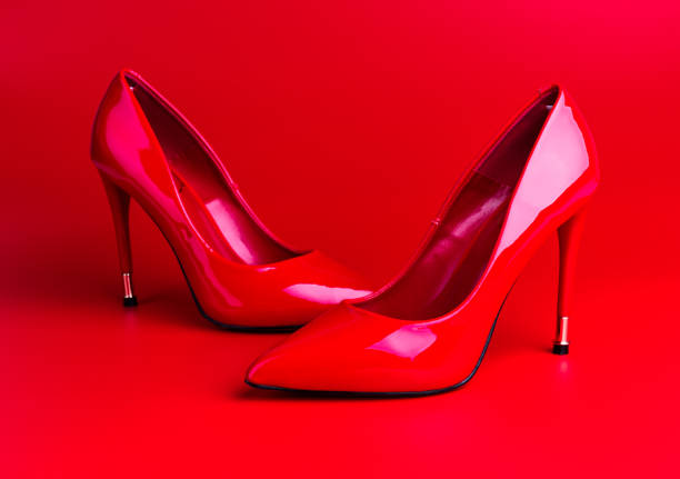 istock Red high heel women shoes on red background 1077162024