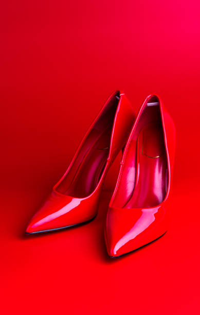 istock Red high heel women shoes on red background 1077163292