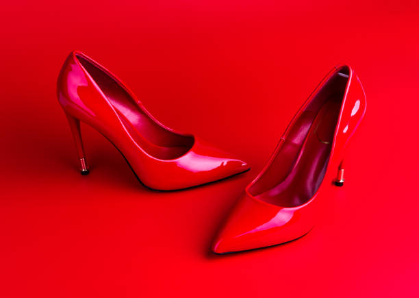 istock Red high heel women shoes on red background 1077163610