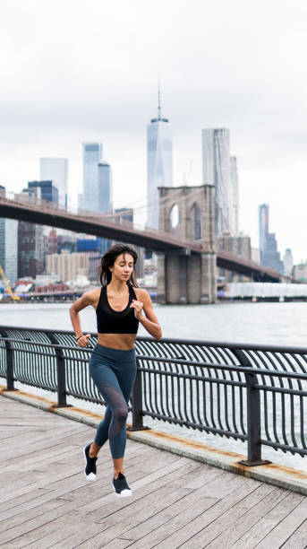 istock Fit young woman jumping and running 1077164102
