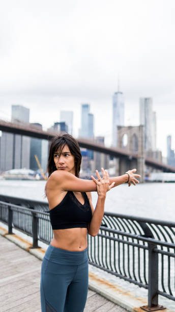 istock Beautiful girl stretching after running on Manhattan bridge 1077164170