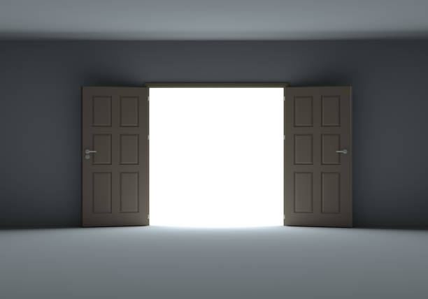 istock Doors opening to show bright light in the darkness 1077171004