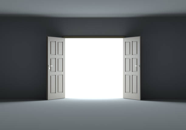 istock Doors opening to show bright light in the darkness 1077171090