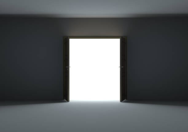 istock Doors opening to show bright light in the darkness 1077171114
