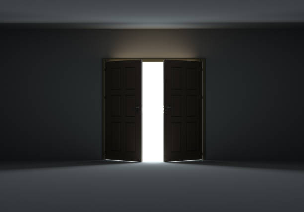 istock Doors opening to show bright light in the darkness 1077171156