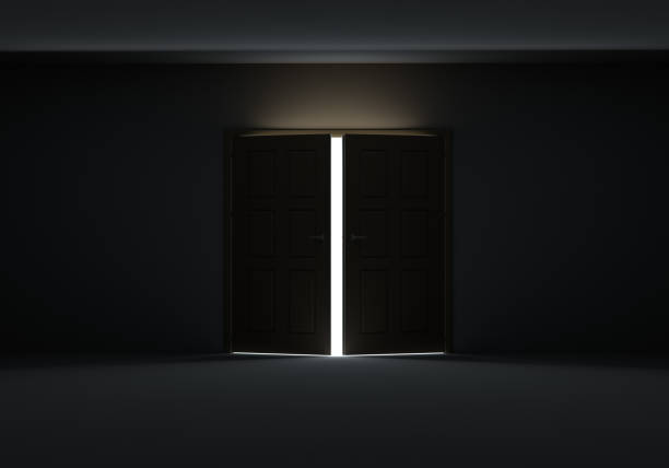 istock Doors opening to show bright light in the darkness 1077171192