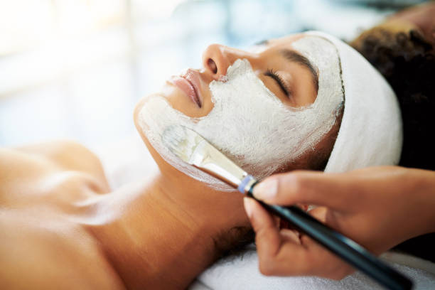 Nothing boosts the skin like a facial Shot of an attractive young woman getting a facial at a beauty spa exfoliation photos stock pictures, royalty-free photos & images