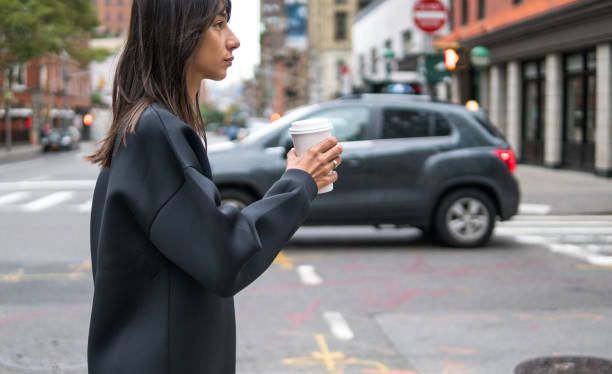 istock New York woman with coffee to go 1077172584