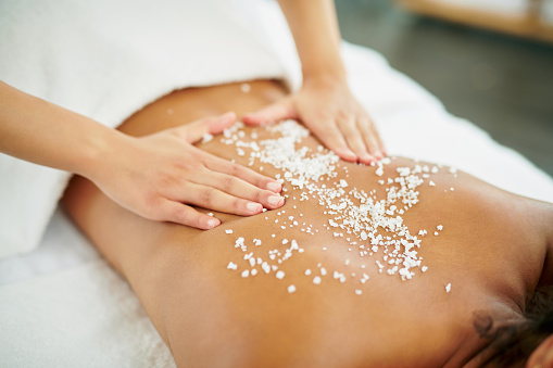 Shot of a young woman getting an exfoliating massage at a spa