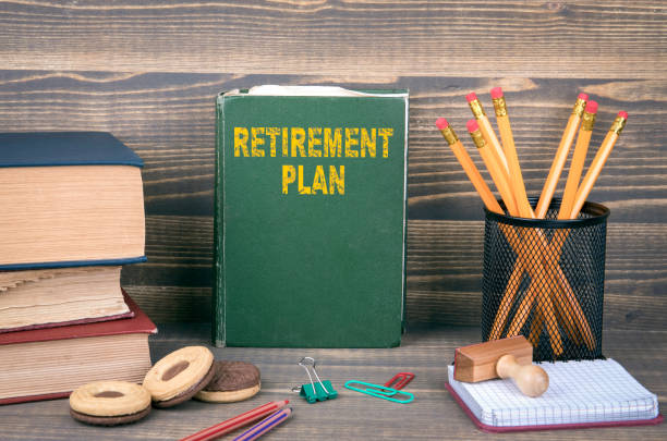 istock Retirement Plan concept. Book on a wooden background 1077190448