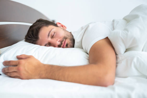 istock The man sleeping on the bed on the white background 1077190984