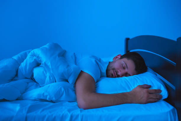 istock The handsome man sleeping on the bed. evening night time 1077191204