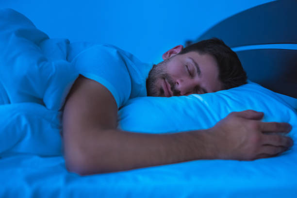 istock The man sleeping on the bed. evening night time 1077191206