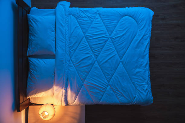 istock The bed near a lamp. view from above, evening night time 1077194016