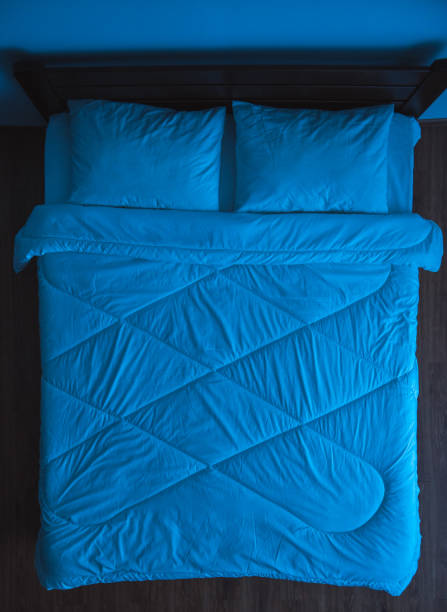 istock The bed with linens. evening night time, view from above 1077194020