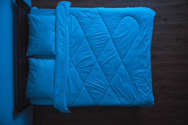 istock The bed with linens. evening night time, view from above 1077194022
