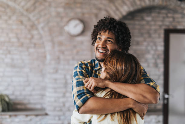 istock Happy black man embracing his girlfriend with affection. 1077195168