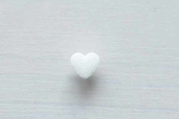 istock White heart on a white background. Design with copy space. Top view 1077196998