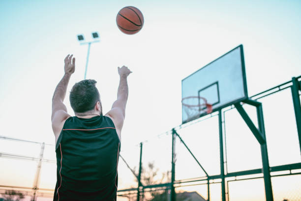 istock Rear View Of Basketball Player Exercising Proper Shooting Technique 1077197688