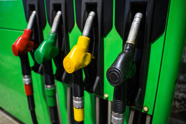 istock Fueling nozzles in different colors on green bright station 1077198458