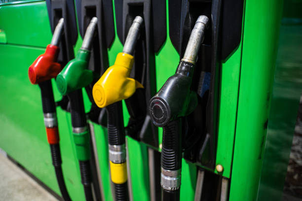 istock Fueling nozzles in different colors on green bright station 1077198492