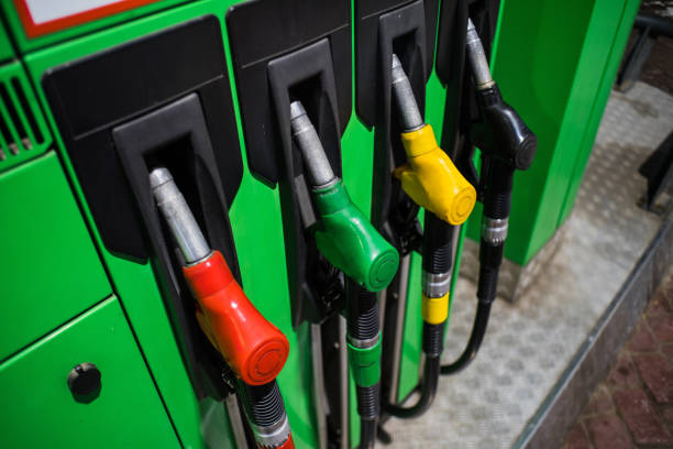 istock Fueling nozzles in different colors on green bright station 1077198516