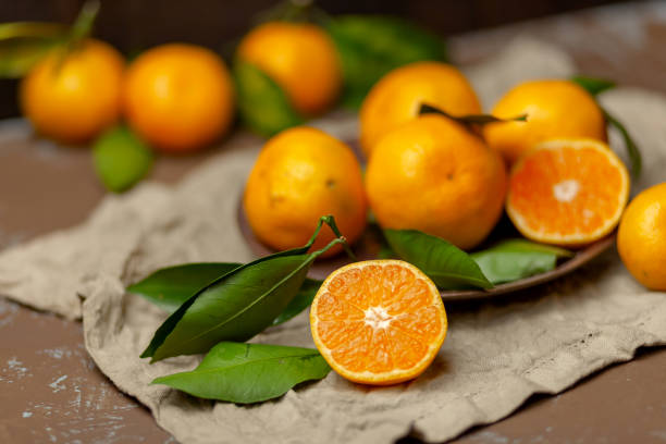 istock Tangerines with leaves on a plate. Natural vitamin 1077200298