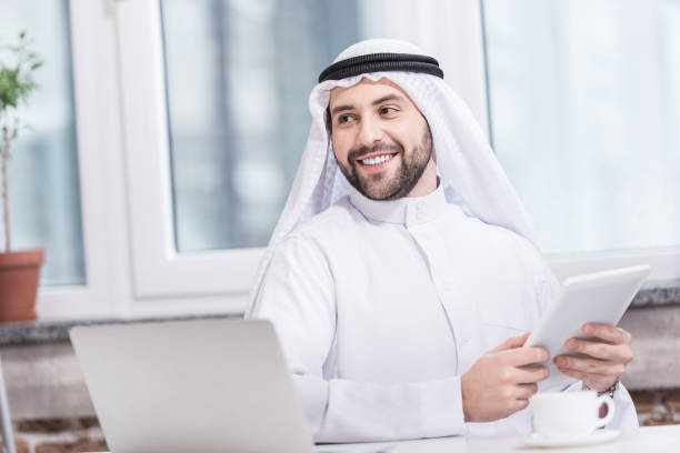 istock Arabian businessman holding digital tablet in modern office 1077202936