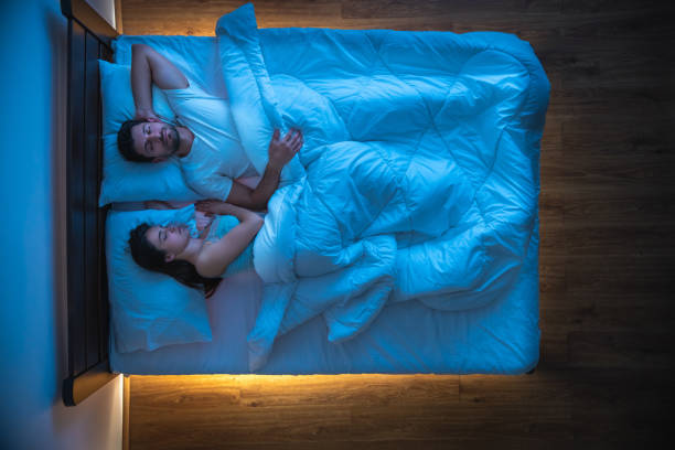istock The couple sleeping on the bed. view from above, evening night time 1077203944