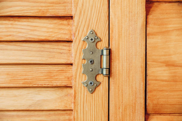 louvered wooden doors.iron hinge.brown yellow color.close-up view