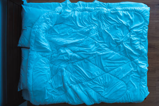 istock The bed with a linens. view from above, evening night time 1077204498