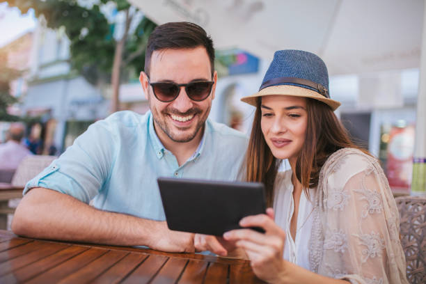 istock Lovely Couple In Cafe Using Digital Tablet, 1077204510