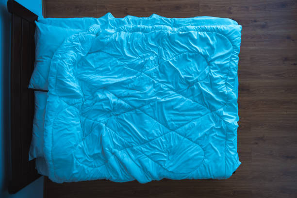 istock The bed with a linens. view from above, evening night time 1077204522