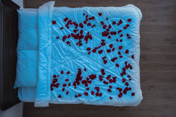 istock The bed with rose petals. evening night time, view from above 1077205714