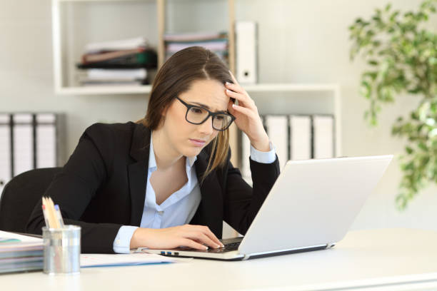 istock Worried office worker reading bad online news 1077205908