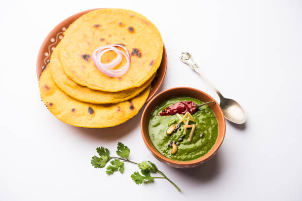 istock Makki di roti with sarson ka saag, popular punjabi main course recipe in winters made using corn breads mustard leaves curry. served over moody background. selective focus 1077206038