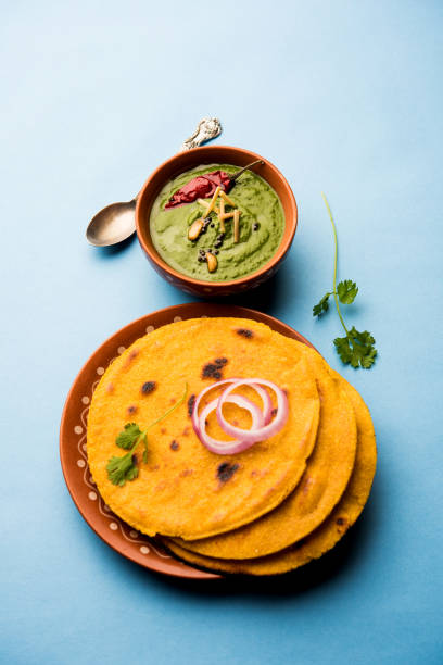 istock Makki di roti with sarson ka saag, popular punjabi main course recipe in winters made using corn breads mustard leaves curry. served over moody background. selective focus 1077206358