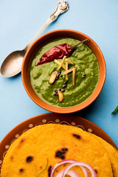 istock Makki di roti with sarson ka saag, popular punjabi main course recipe in winters made using corn breads mustard leaves curry. served over moody background. selective focus 1077206384
