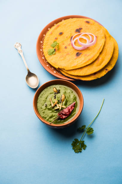 istock Makki di roti with sarson ka saag, popular punjabi main course recipe in winters made using corn breads mustard leaves curry. served over moody background. selective focus 1077206484