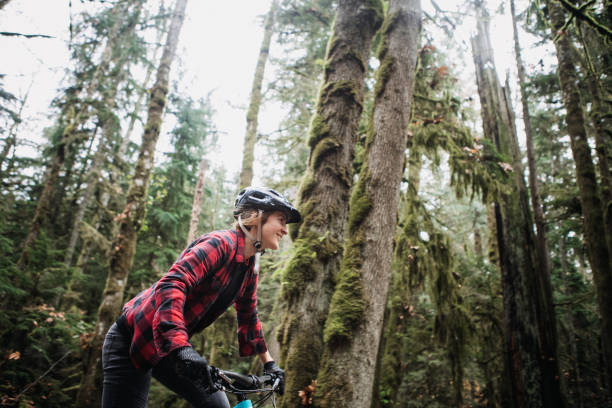 istock Woman Mountain Biking On Forest Trails 1077207190