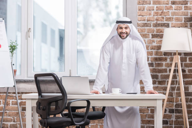 istock Arabian businessman standing and smiling in office 1077208764