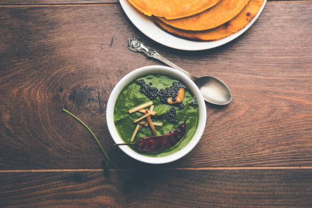 istock Makki di roti with sarson ka saag, popular punjabi main course recipe in winters made using corn breads mustard leaves curry. served over moody background. selective focus 1077208978