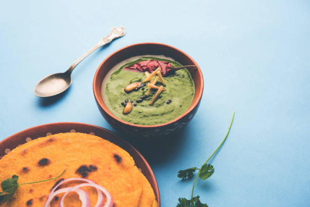 istock Makki di roti with sarson ka saag, popular punjabi main course recipe in winters made using corn breads mustard leaves curry. served over moody background. selective focus 1077209358