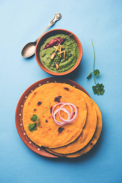 istock Makki di roti with sarson ka saag, popular punjabi main course recipe in winters made using corn breads mustard leaves curry. served over moody background. selective focus 1077209408