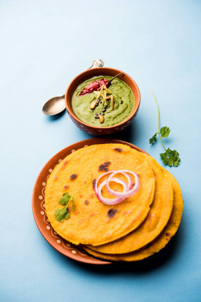 istock Makki di roti with sarson ka saag, popular punjabi main course recipe in winters made using corn breads mustard leaves curry. served over moody background. selective focus 1077209426