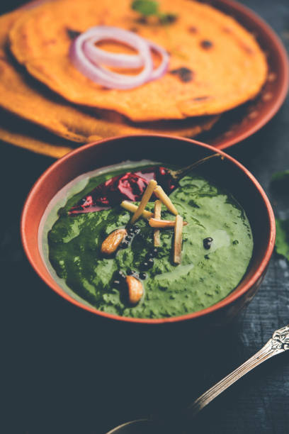 istock Makki di roti with sarson ka saag, popular punjabi main course recipe in winters made using corn breads mustard leaves curry. served over moody background. selective focus 1077209620