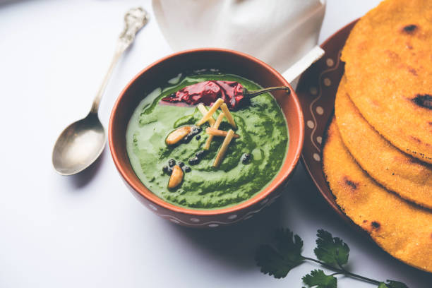 istock Makki di roti with sarson ka saag, popular punjabi main course recipe in winters made using corn breads mustard leaves curry. served over moody background. selective focus 1077210128