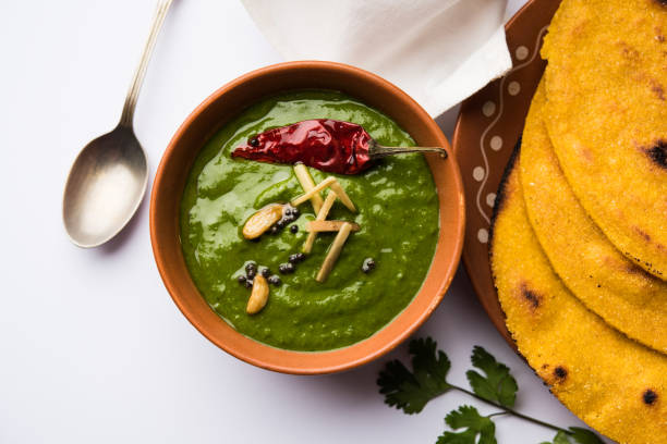 istock Makki di roti with sarson ka saag, popular punjabi main course recipe in winters made using corn breads mustard leaves curry. served over moody background. selective focus 1077210160