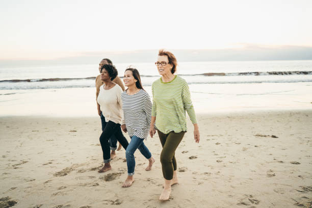 istock Active seniors Walking on the beach 1077212000